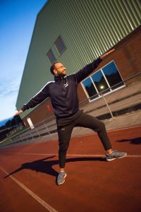 A runner is performing a strength routine